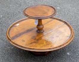 A Victorian walnut two tier graduated Lazy Susan, on an octagonal weighted baluster support.