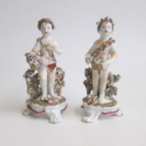 A pair of English porcelain Cherubs, probably modelled as Spring with flowers and Autumn with