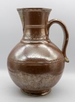 An 18th Century salt glazed stone ware jug, the rim incised "John & Elizabeth Bancroft of Barrow