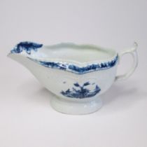 A Worcester blue and white Sauce boat of pleated and moulded form, painted with two Chinese
