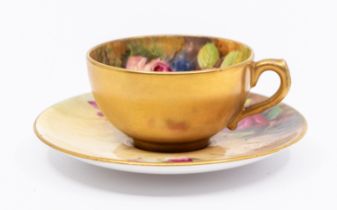 A matched Royal Worcester coffee cup and saucer,  the interior cup and saucers painted with pink