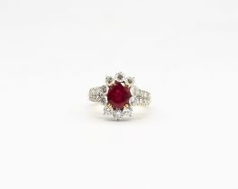 A ruby and diamond 18ct gold ring, comprising a oval mixed cut ruby, weighing approx 2.30carats,