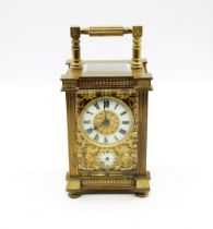 A French late 19th Century gilt brass carriage clock, cream enamel dial with Roman numerals above
