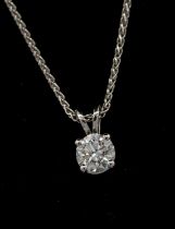 A diamond and 18ct white gold solitaire pendant, comprising a round brilliant cut diamond weighing