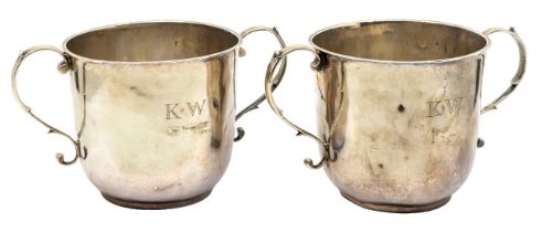 A pair of George I silver porringer cups, plain bodies with S scroll handles, engraved with initials