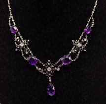 An Edwardian amethyst and diamond set platinum necklace, comprising a central scroll wire work motif