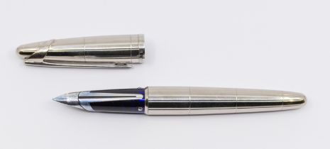 A Waterman silver fountain pen with ridged barrel and cover, the white gold nib stamped 18K - 750 (