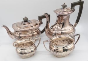 An Elizabeth II silver four piece tea set consisting of coffee pot, tea pot, sugar bowl and milk