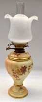 A Royal Worcester ceramic oil lamp base, with a removable cover, both cover and base have hand