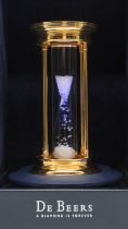 De Beers- a limited edition gold plated hourglass, containing a cascade of 2000 natural rough