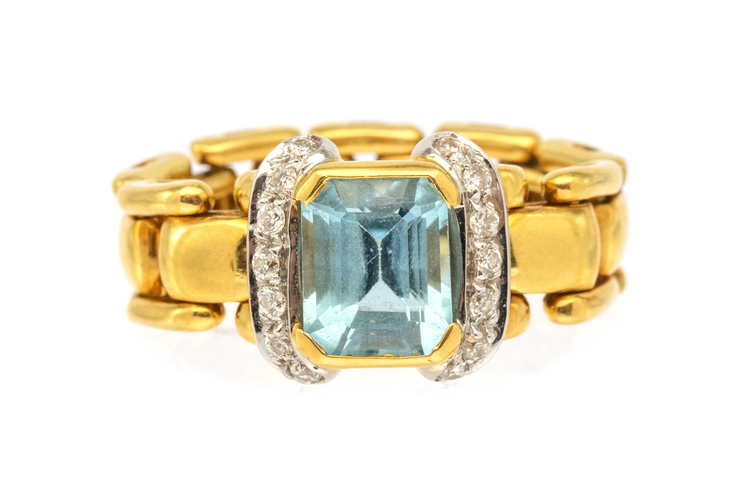 A blue topaz and diamond 18ct gold chain link ring, comprising an emerald cut blue topaz, rub over