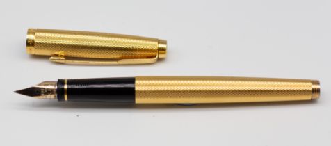 A Parker 585 engine turned fountain pen and cover, the nib stamped 14K (1)  Further details: minor