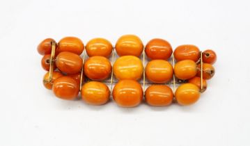A graduated butterscotch copal/ amber type bracelet, (assumed pressed) comprising three rows of