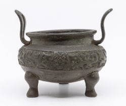 A 19th century Chinese bronze censor, twin handled and three footed, impressed circular stamp to