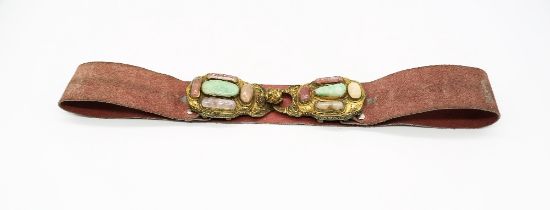 A quartz set gilt metal mounted belt buckle, embossed floral decoration with dragon head hook, width