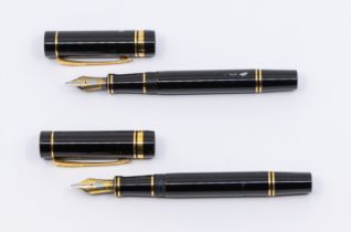 Two vintage Parker Duofold fountain pens, both black with 18K gold nibs, both stamped 18K and 750 (