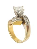 A diamond and 18ct gold two tone cross over ring, comprising a square modified brilliant cut,