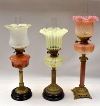 A small collection of three late 19th/early 20th century oil lamps, various designs to include; a