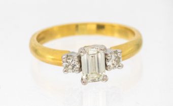 *****WITHDRAWN **** A diamond and 18ct gold three stone ring, comprising a central emerald cut