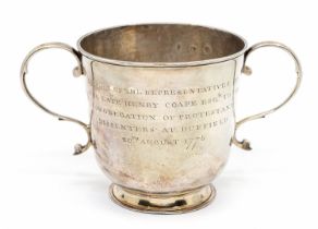 A George I silver two handled porringer cup, plain body with S scroll handles on stepped base, the