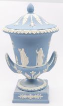 Wedgwood - a blue and white jasperware twin handled urn and cover, on square footed base, marked