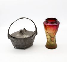An early 20th century Loetz style iridescent glass vase of swirled stylish form, mixed ruby, green
