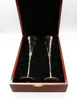 A pair of Millenium, Britannia standard silver champagne flutes of modernist plain stylish shape, on