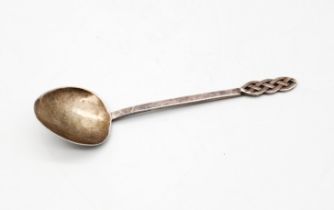 AE Jones - an Arts & Crafts style silver spoon, having stylised knot shaped terminal, thin stem