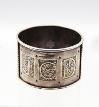 Philip Frederick Alexander  - an Arts & Crafts circular silver napkin ring, with stylised knotted