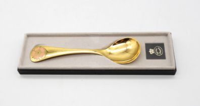 Georg Jensen - a 1970s silver gilt and enamel commemorative spoon, with enamelled pink flower design