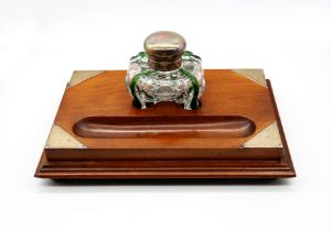 A late Victorian silver topped glass inkwell, with a stylish green infused clear glass bottle of