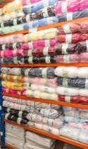 A large collection of double knitting wool in various colours along with 6 rolls of material 90cm