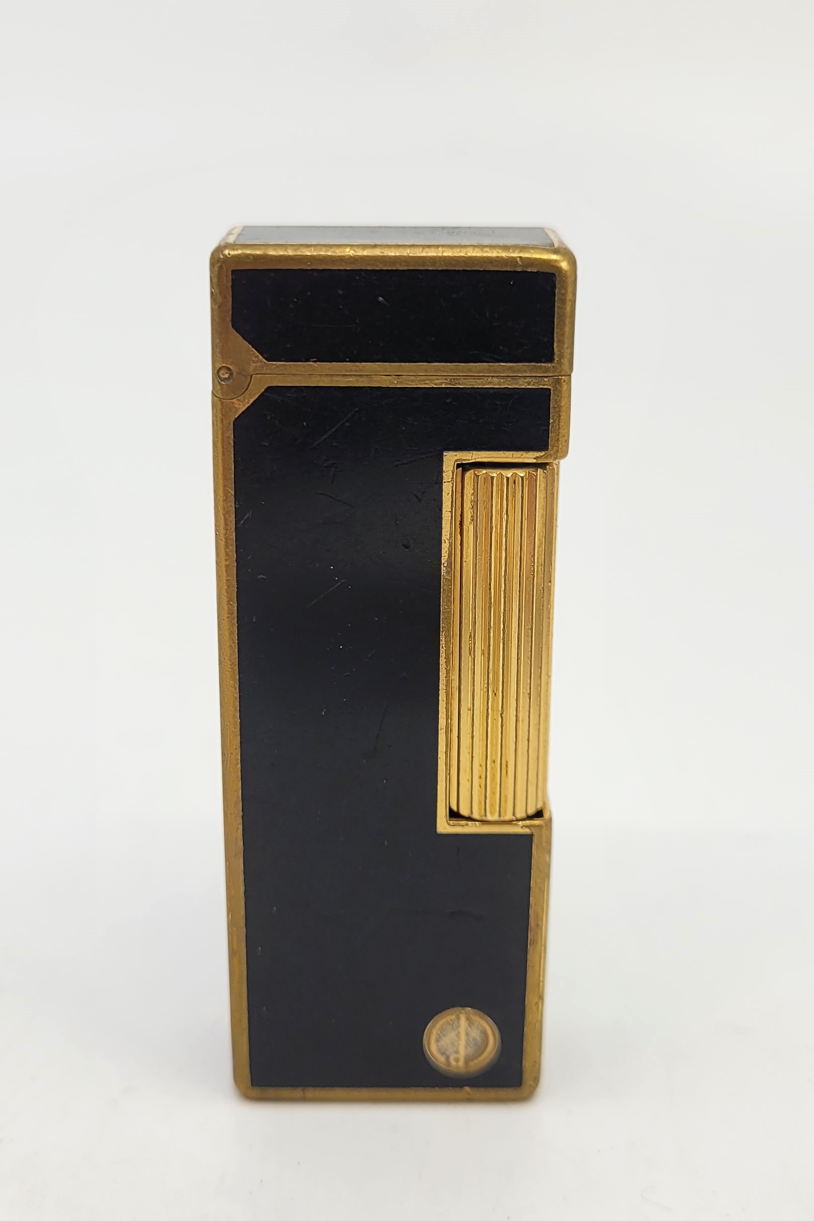 A Dunhill gilt metal and black enamel Rollagas cigarette lighter.