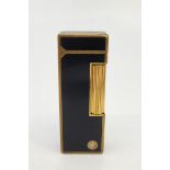 A Dunhill gilt metal and black enamel Rollagas cigarette lighter.