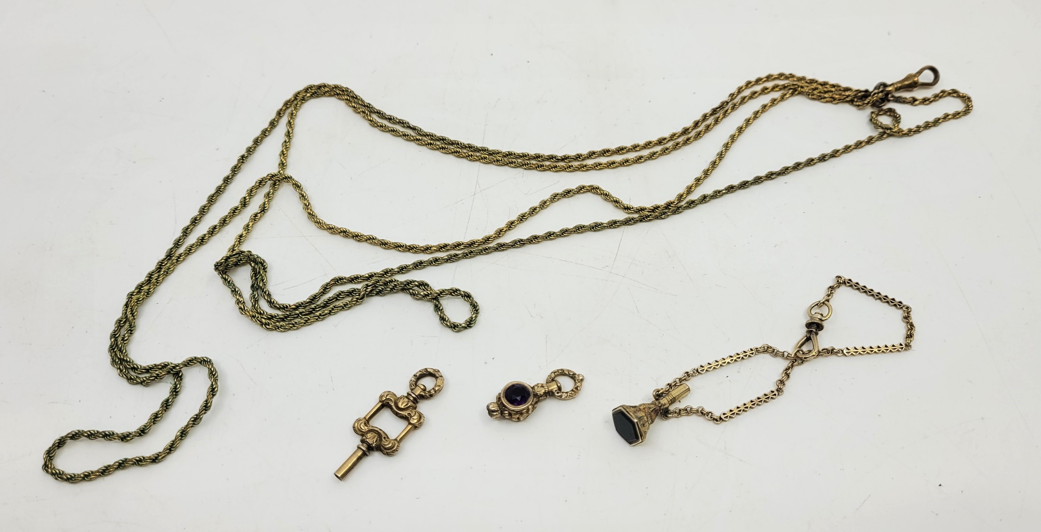 A yellow metal fancy link chain, suspending a gilt metal and black onyx set seal/watch key, together - Image 3 of 3