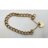 A 9ct. gold curb link bracelet, with 9ct. gold heart padlock clasp. (40.0g)