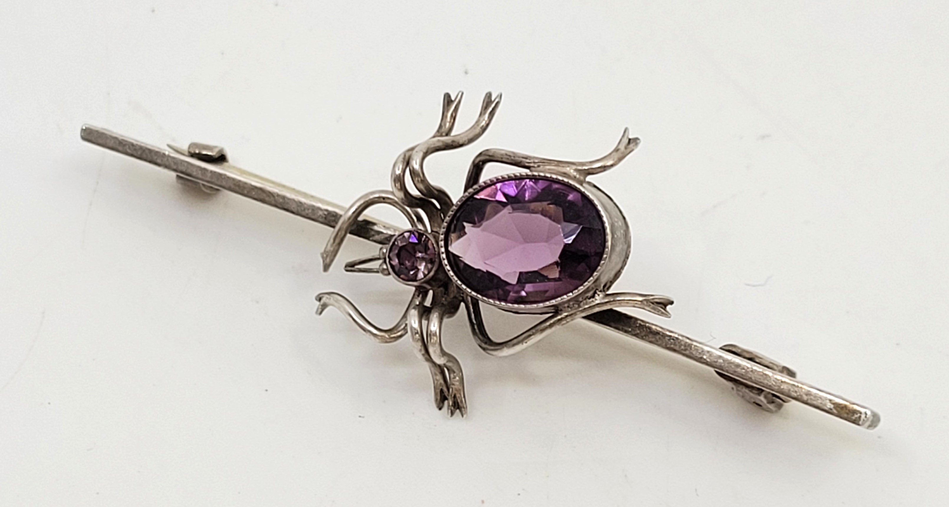 A Charles Horner silver and paste spider brooch, Chester 1921, the spider rub-over set faceted