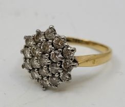 An 18ct. gold diamond cluster ring, having domed hexagonal mount pave set twenty-one round brilliant
