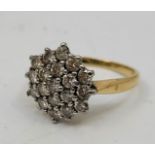 An 18ct. gold diamond cluster ring, having domed hexagonal mount pave set twenty-one round brilliant