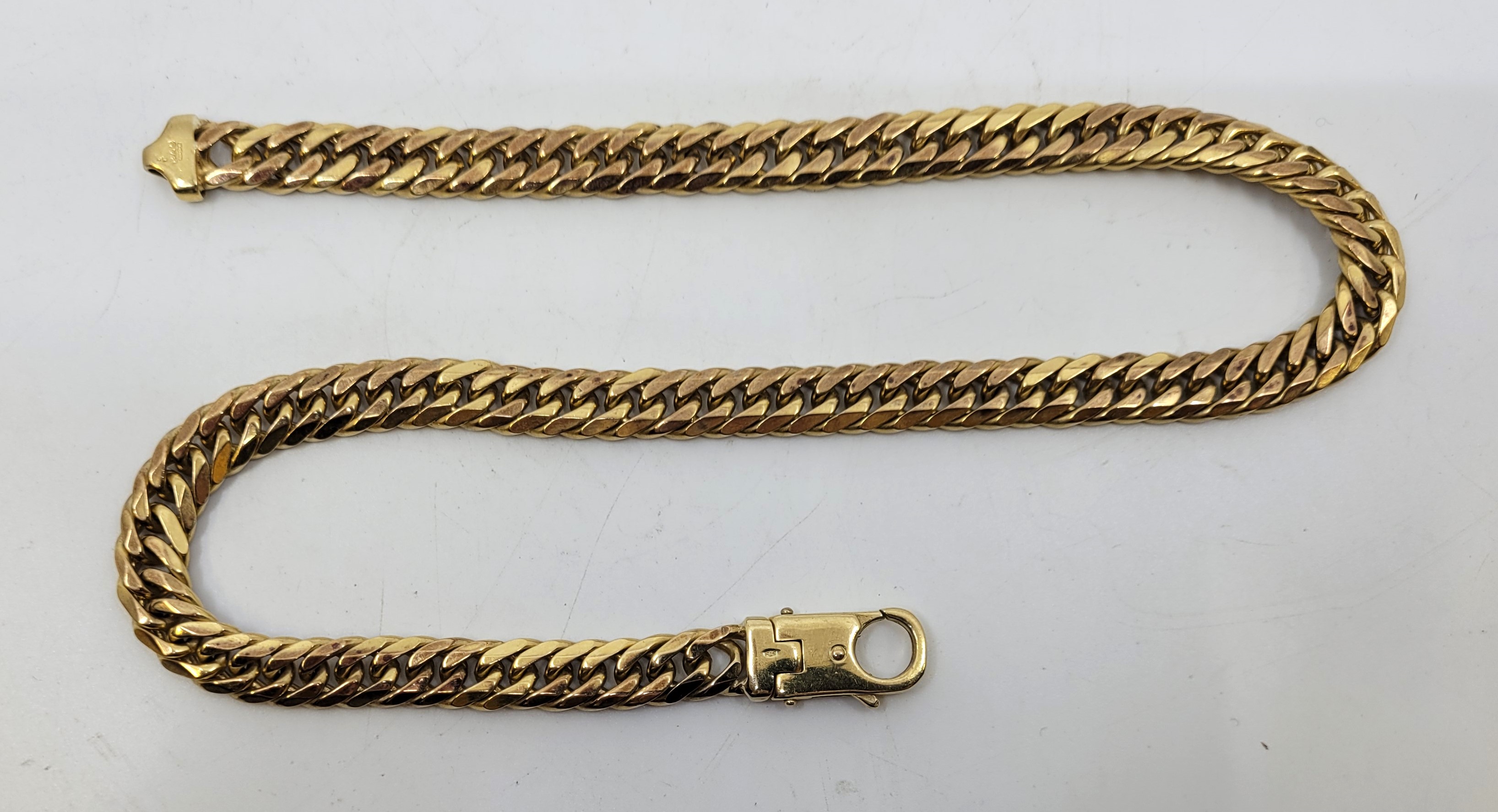 A 9ct. gold flat curb link chain, length 45.5cm. (86.6g)