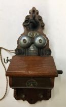 A vintage  L M ERICSSON & CO Stockholm, 285768 wooden wall mounted telephone with magneto crank