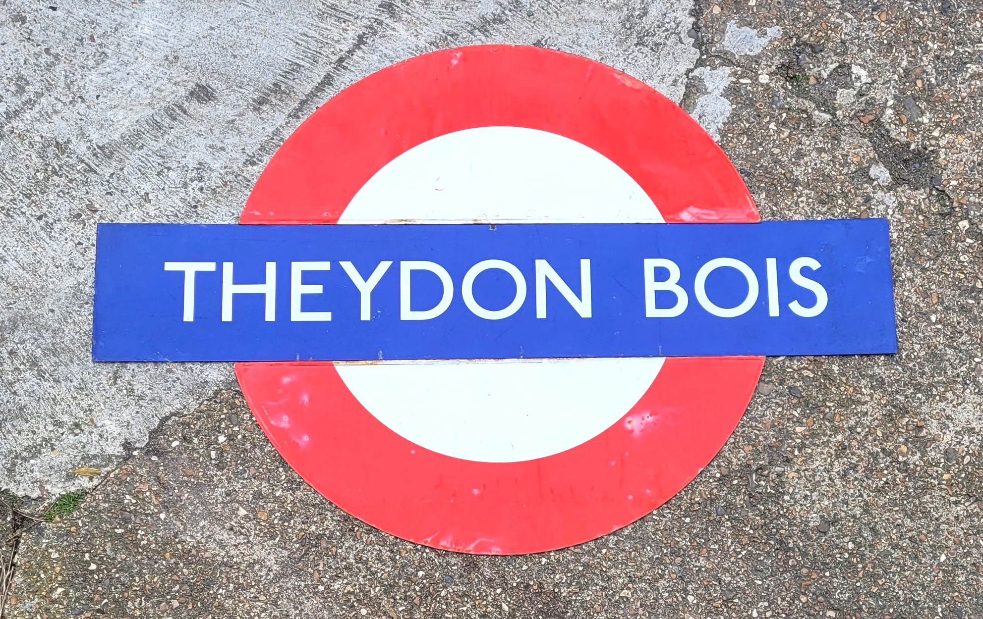 "Theydon Bois", an original three piece enamelled London Underground station sign, length 149cm.