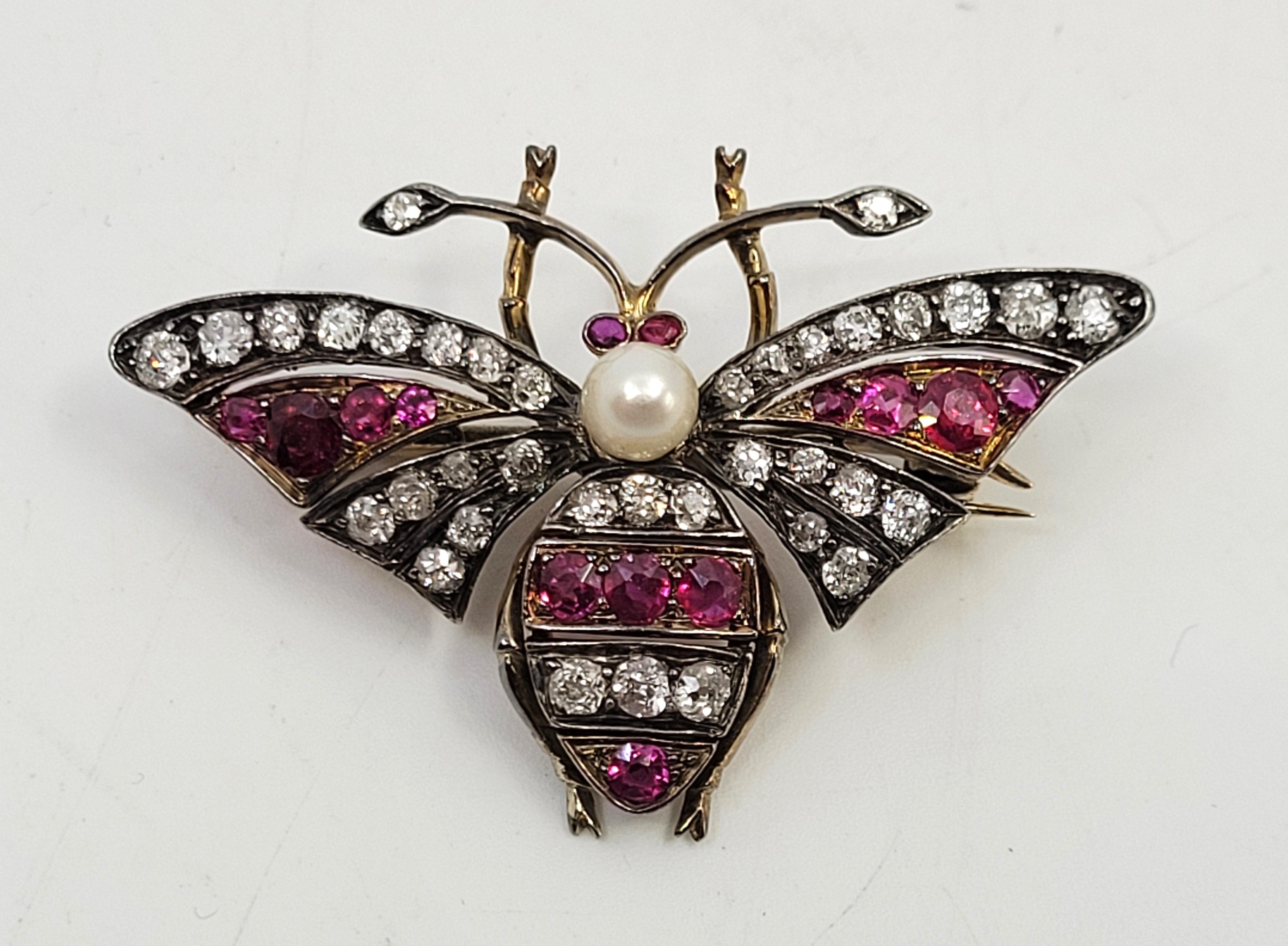 An early 20th century precious mixed metal, diamond, ruby and pearl butterfly brooch, set central