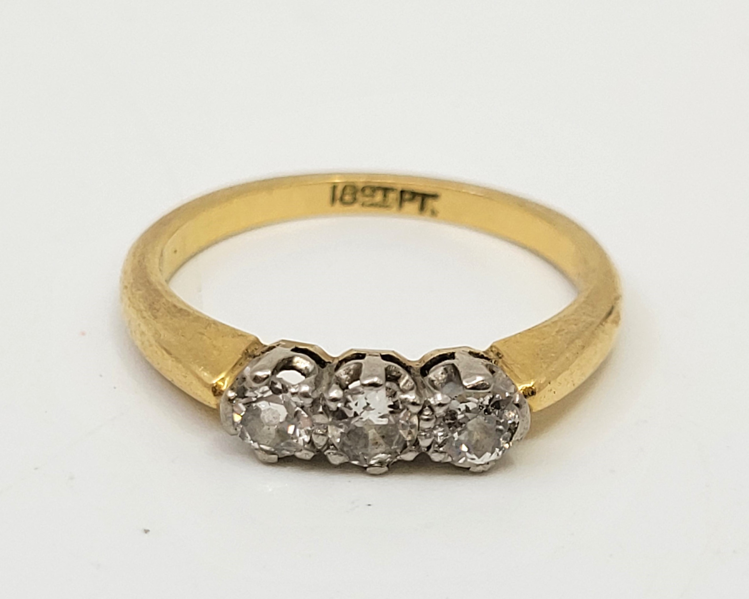 An 18ct. gold and platinum three stone diamond ring, set three round brilliant cut diamonds (ETDW - Image 2 of 9