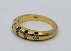 An 18ct. gold and five stone diamond ring, flush set five round brilliant cut diamonds (ETDW 0.35