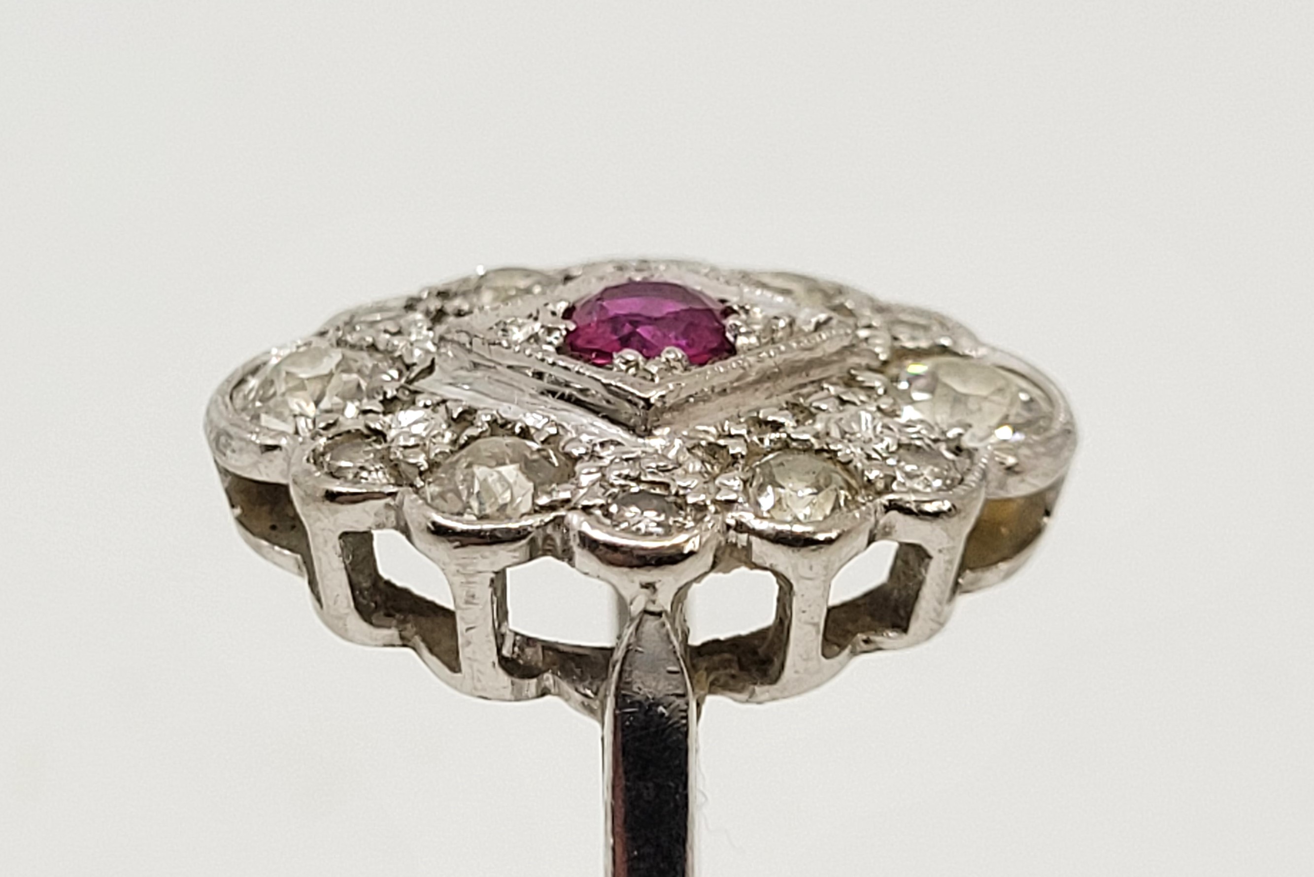 An 18ct. white gold, diamond and ruby ring, in the Art Deco style, having lobed oval mount set mixed - Image 4 of 12