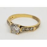 A precious yellow metal and diamond ring, four claw set round brilliant-cut diamond to centre (EDW