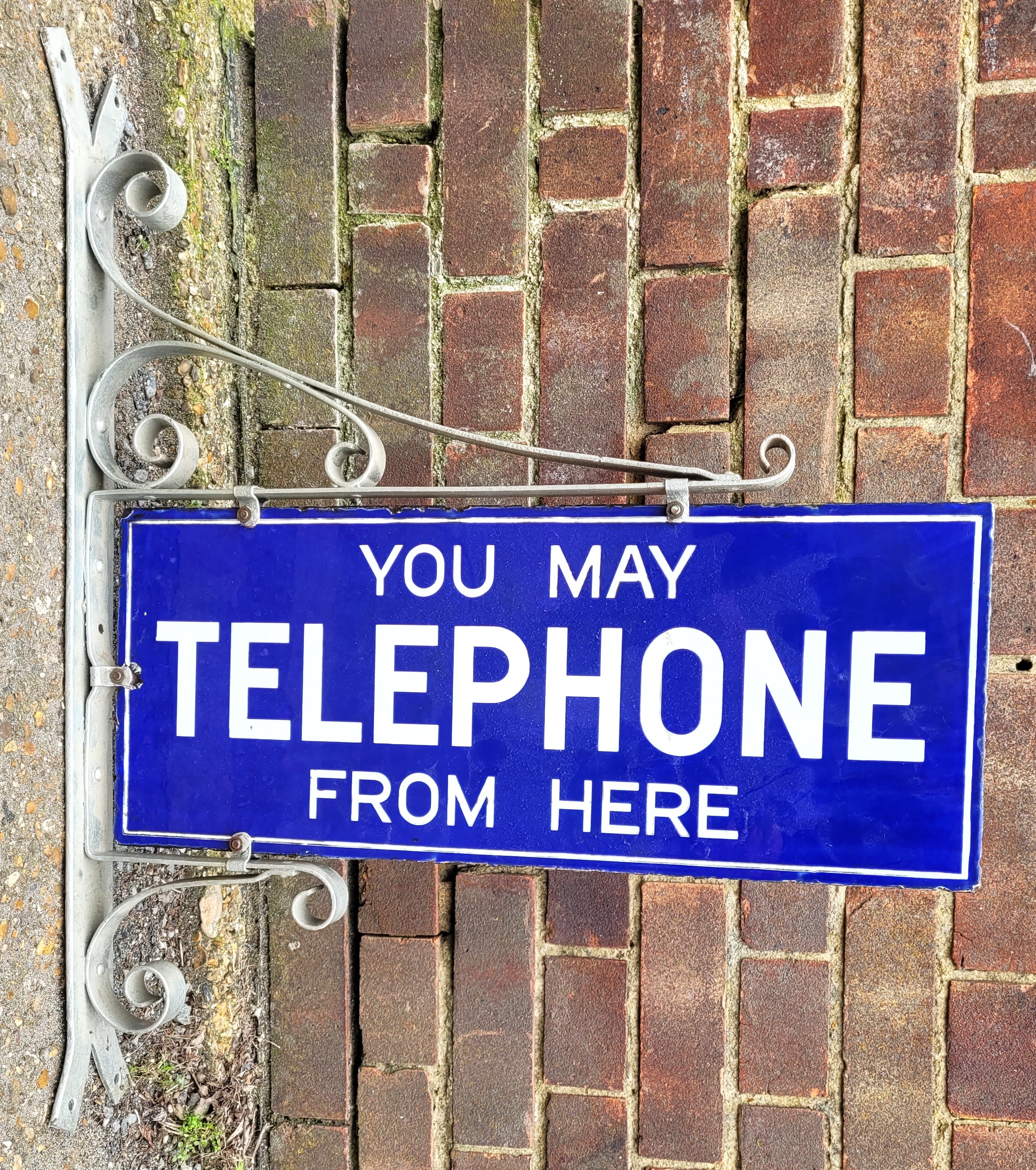 "You May Telephone From Here", An original double sided enamelled sign, 55.8cm x 23cm, with