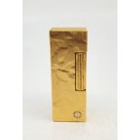 A Dunhill gilt metal Rollagas cigarette lighter, with textured finish.