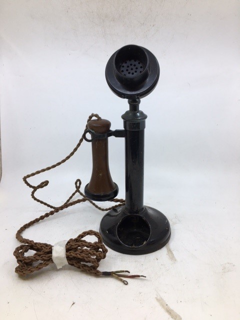 A vintage black stick telephone (a/f)